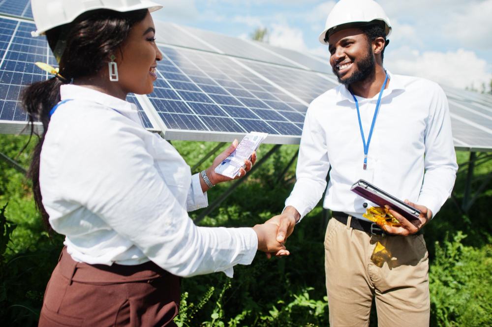 Wobotron team members shaking hands at a solar project site